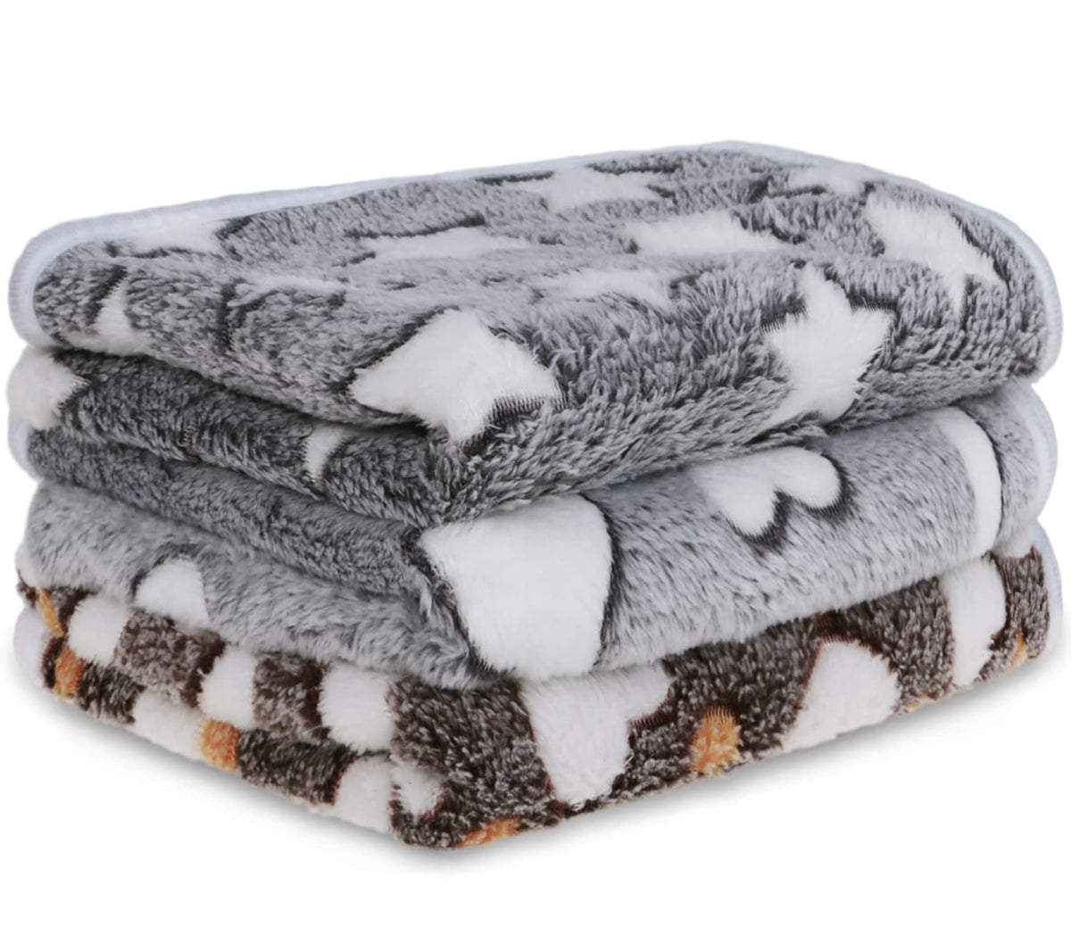 Soft flannel pet blankets folded and stacked in grey, white and brown heart patterns