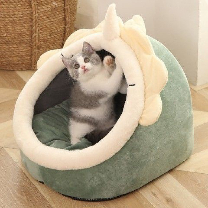 Cozy cat cave bed in sage green with soft cream rim and a kitten playing inside